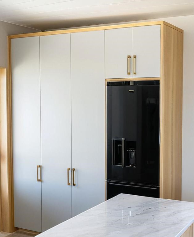 A Beach Kitchen with a Black Fridge